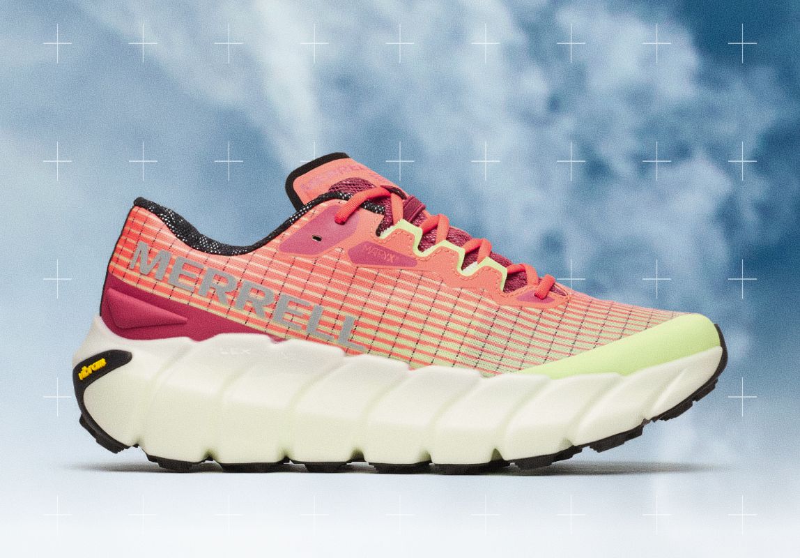 Persons legs sitting and wearing pink MTL Adapt Matryx shoe on a rock.